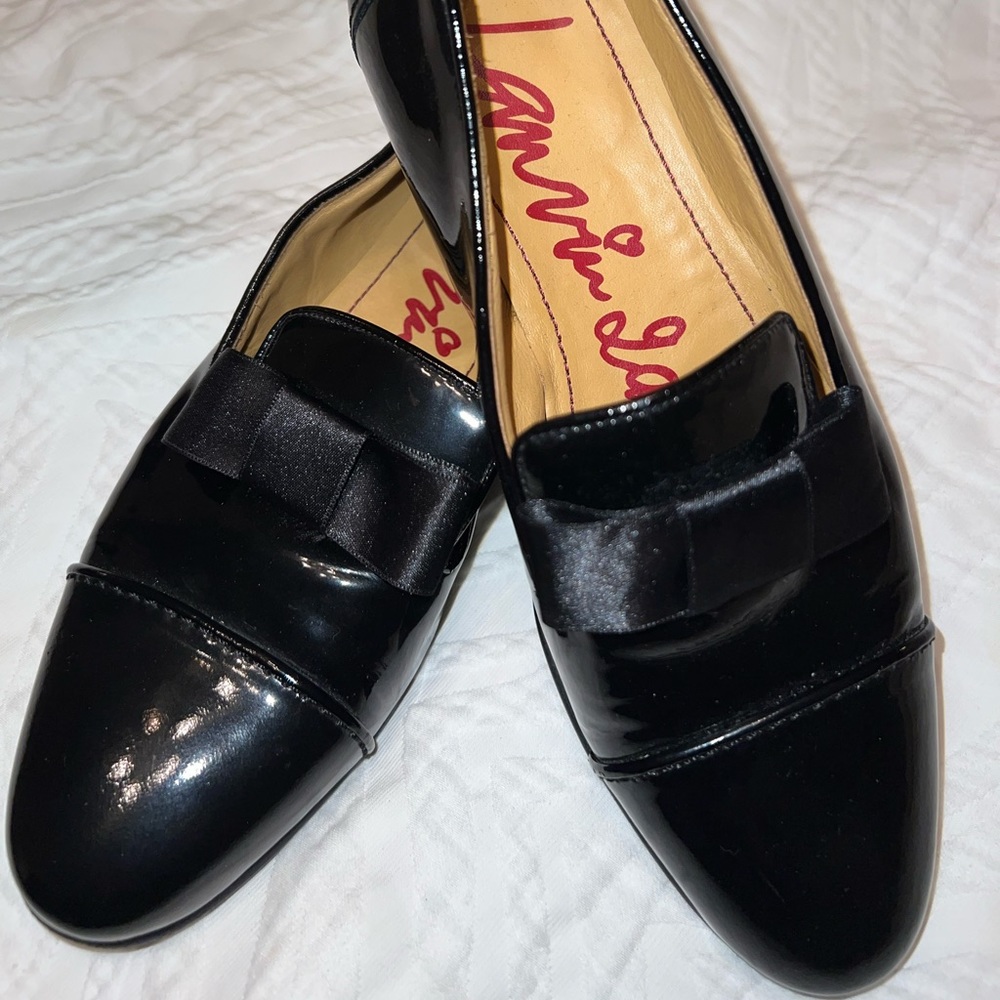 Lanvin, black patent leather loafers with satin bow.